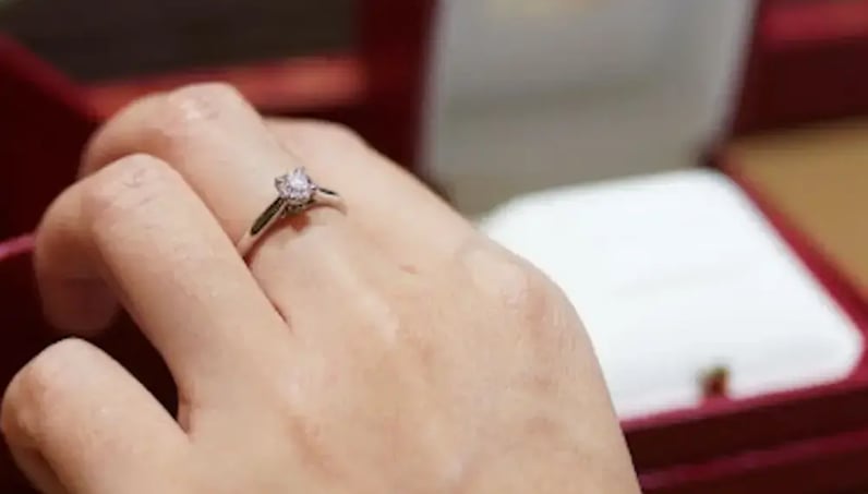 woman trying on engagement ring