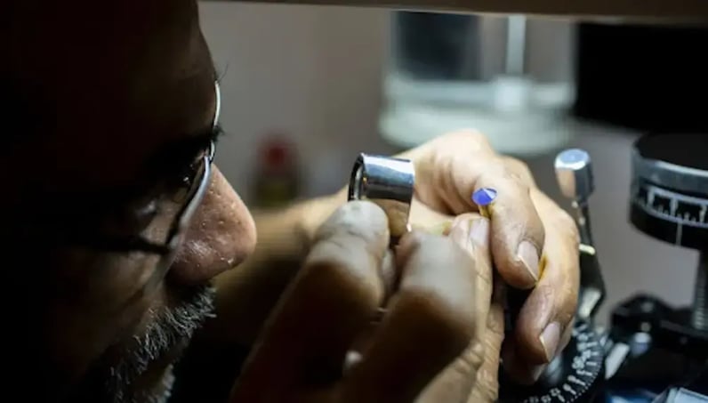 jeweller looking at gem stone (1)